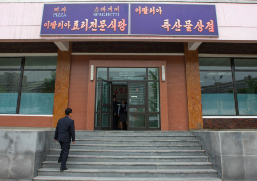 North Korean man entering a pizzeria restaurant, Pyongan Province, Pyongyang, North Korea