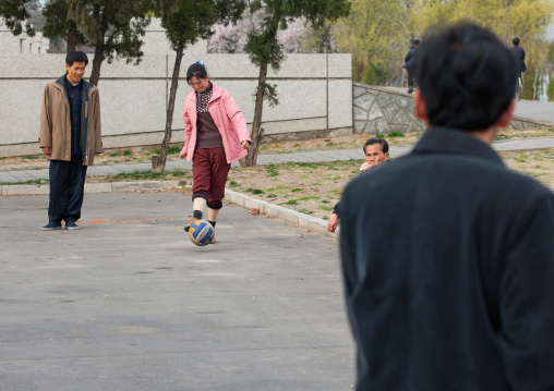 North Korean people playing football in the street, Pyongan Province, Pyongyang, North Korea