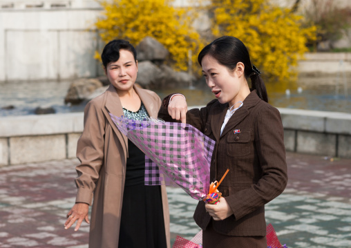 North Korean women with a bunch of flowers in the street, Pyongan Province, Pyongyang, North Korea