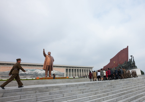 Soldiers passing by statue of Kim il Sung in the Grand monument on Mansu hill, Pyongan Province, Pyongyang, North Korea