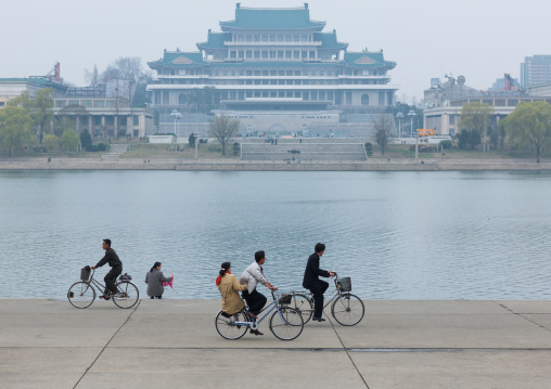 North Korean people riding bicycles along Taedong river, Pyongan Province, Pyongyang, North Korea