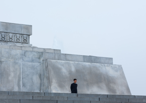 North Korean man standing at the bottom of Juche tower, Pyongan Province, Pyongyang, North Korea