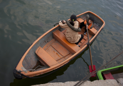 North Korean people in rowing boat on Taedong river, Pyongan Province, Pyongyang, North Korea