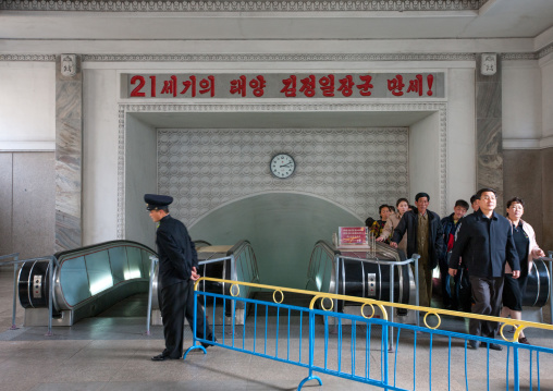 North Korean people coming out from a subway station with the slogan saying long live general Kim Jong-il the 21st century sun, Pyongan Province, Pyongyang, North Korea