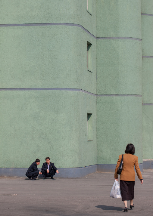 North Korean people squatting in the street, Pyongan Province, Pyongyang, North Korea