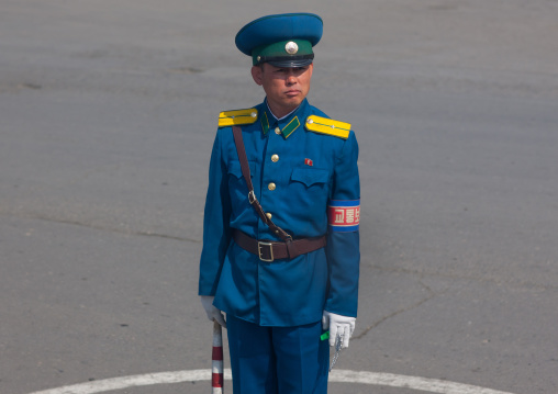 North Korean male traffic security officer in blue unform in the street, South Pyongan Province, Nampo, North Korea