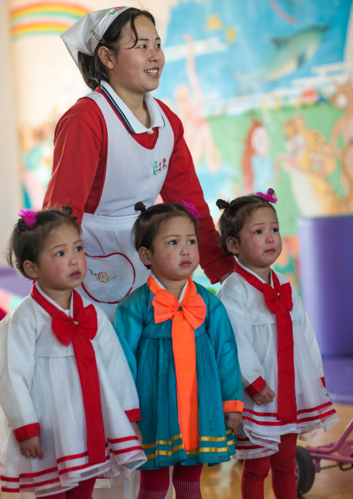 North Korean triplets in an orphanage with a nurse, South Pyongan Province, Nampo, North Korea