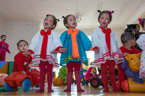 North Korean triplets girls singing in an orphanage, South Pyongan Province, Nampo, North Korea