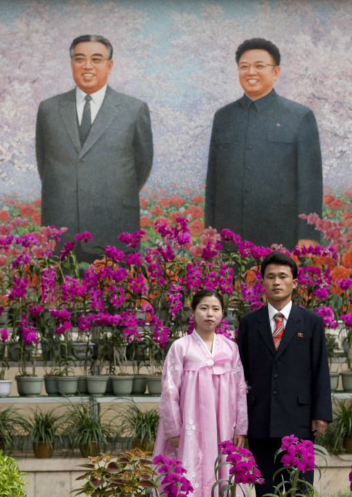 North Korean couple posing in the international Kimilsungia and Kimjongilia festival, Pyongan Province, Pyongyang, North Korea