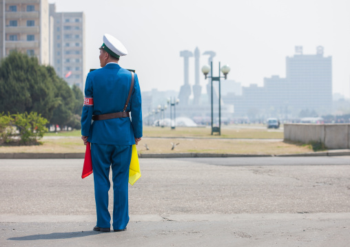 North Korean male traffic security officer in blue uniform in the street, Pyongan Province, Pyongyang, North Korea