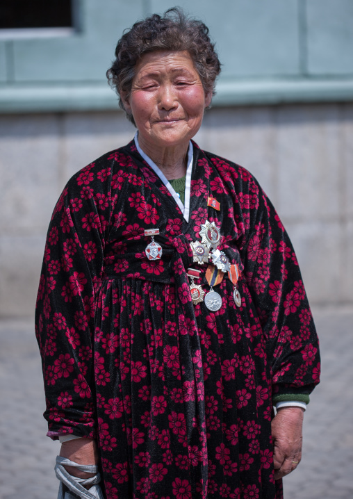 North Korean woman wearing medals from the war, Pyongan Province, Pyongyang, North Korea