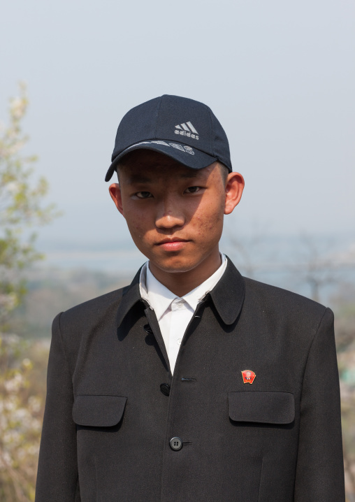 Portrait of a young North Korean man wearing a addidas cap, Pyongan Province, Pyongyang, North Korea