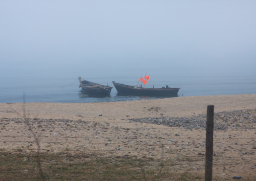 Boats on a beach in the mist, Kangwon Province, Wonsan, North Korea