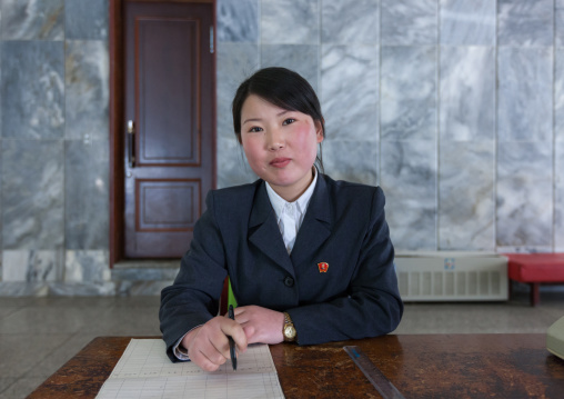 Portrait of a North Korean woman sit at a desk in the Songdowon international children's camp, Kangwon Province, Wonsan, North Korea