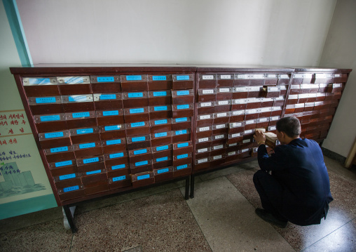 North Korean man searching a book reference in the Grand people's study house, Pyongan Province, Pyongyang, North Korea