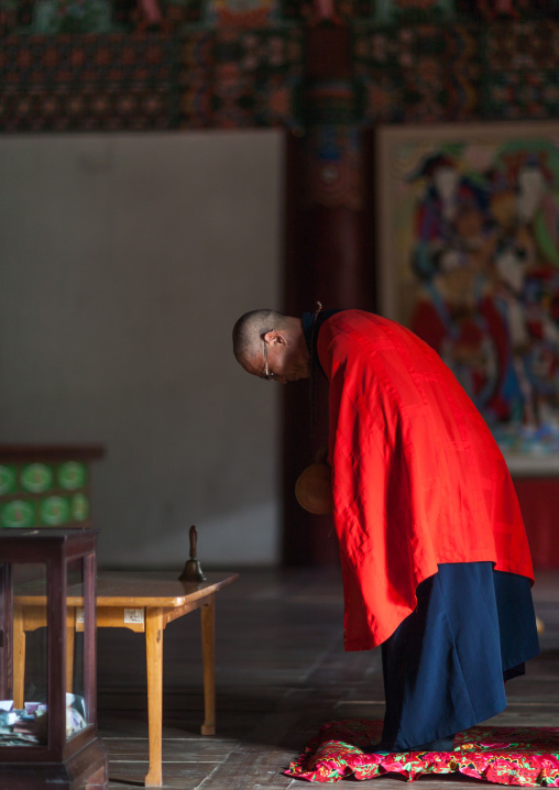 North Korean monk praying in Pohyon-sa Korean buddhist temple, Hyangsan county, Mount Myohyang, North Korea