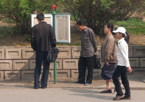 North Korean people reading the newspaper displayed in the street, Pyongan Province, Pyongyang, North Korea