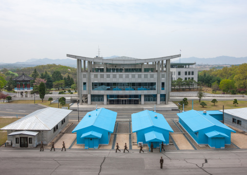 North Korean soldiers standing in front of the United Nations conference rooms on the demarcation line in the Demilitarized Zone, North Hwanghae Province, Panmunjom, North Korea