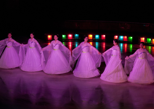 Dancers in pink traditional choson-ot ice skating in the circus, Pyongan Province, Pyongyang, North Korea