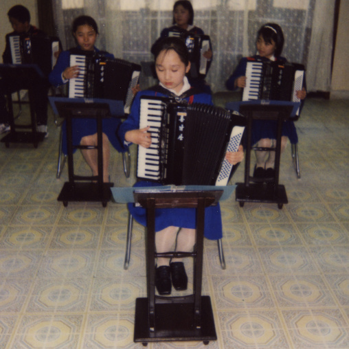 Polaroid of accordion classroom with North Korean students in Mangyongdae children's palace, Pyongan Province, Pyongyang, North Korea