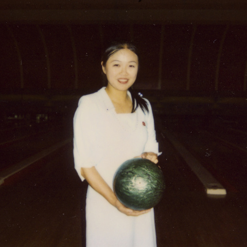 Polaroid of a smiling North Korean woman in a bowling, Pyongan Province, Pyongyang, North Korea
