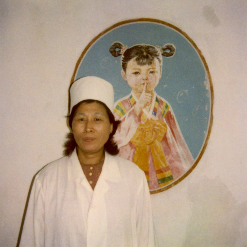 Polaroid of a nurse in front of a poster telling the children to be silent, Pyongan Province, Pyongyang, North Korea