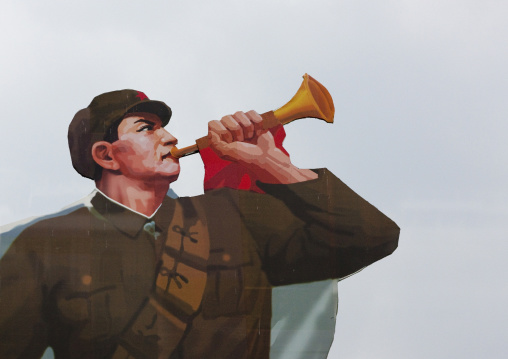 Painted billboard of a North Korean soldier blowing in a horn on Kim il Sung square, Pyongan Province, Pyongyang, North Korea