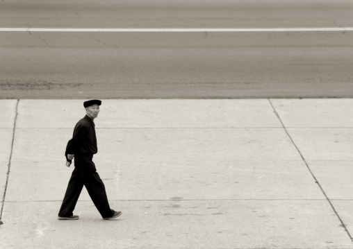 North Korean man walking in the street, Pyongan Province, Pyongyang, North Korea