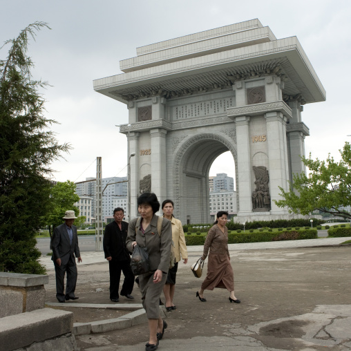 North Korean people passing in front of the arch of trimuph, Pyongan Province, Pyongyang, North Korea