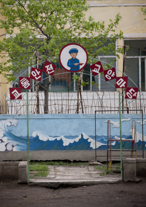 Children playground in a school with the slogans traffic security and cultural area, South Pyongan Province, Chongsan-ri Cooperative Farm, North Korea