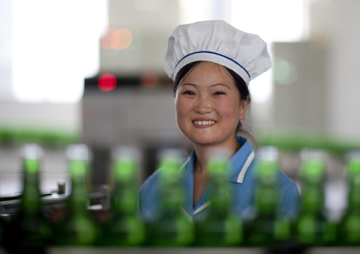 Smiling North Korean worker woman in kangso yaksu mineral water factory, South Pyongan Province, Nampo, North Korea