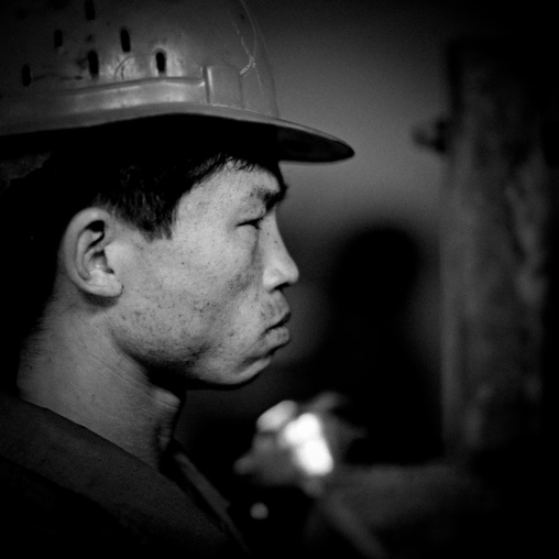 North Korean worker with a helmet in a steel factory, South Pyongan Province, Nampo, North Korea