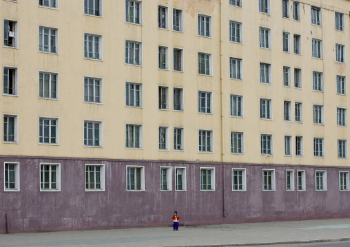 North Korean child in front a building in the street, Pyongan Province, Pyongyang, North Korea