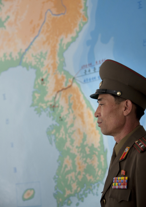 North Korean officer in front of a Korea map in the joint security area of the Demilitarized Zone, North Hwanghae Province, Panmunjom, North Korea