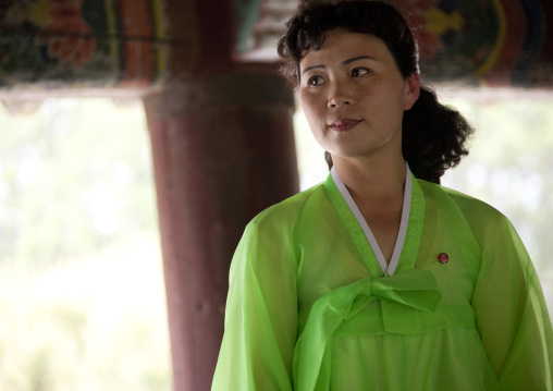 Smiling North Korean woman dressed in green choson-ot, North Hwanghae Province, Kaesong, North Korea
