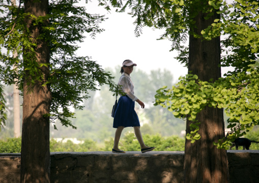 North Korean teenage girl walking in a park, North Hwanghae Province, Kaesong, North Korea
