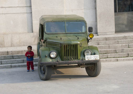 North Korean boy near an old North Korean army jeep, North Hwanghae Province, Kaesong, North Korea