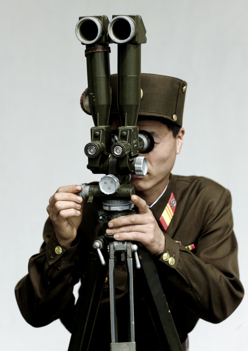 North Korean soldier looking south Korea with binoculars at the Demilitarized Zone, North Hwanghae Province, Panmunjom, North Korea