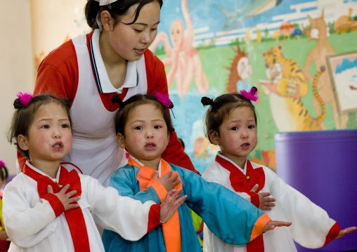 North Korean triplets in an orphanage with a nurse, South Pyongan Province, Nampo, North Korea