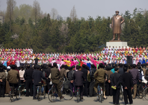 North Korean women dancing and singing in front of Kim il Sung statue in a village, South Pyongan Province, Nampo, North Korea