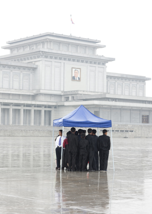 North Korean people under the rain in Kumsusan palace of the sun that serves as the mausoleum for Kim Il-sung and Kim Jong-il, Pyongan Province, Pyongyang, North Korea
