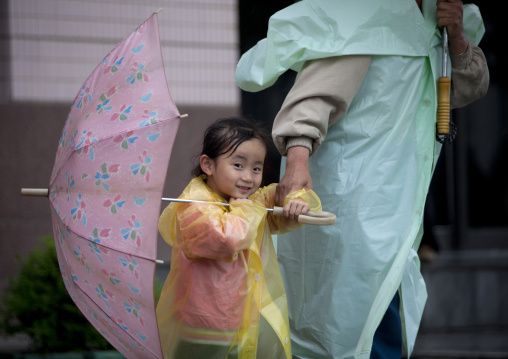 North Korean girl with an umbreall in the street, Pyongan Province, Pyongyang, North Korea