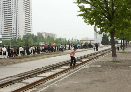 North Korean people in the street queueing to wait a bus, Pyongan Province, Pyongyang, North Korea