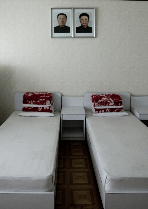 A bedroom in Songdowon international children's camp with the Dear Leaders portraits, Kangwon Province, Wonsan, North Korea