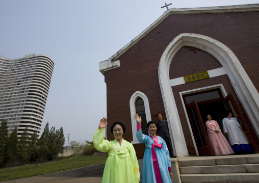 North Korean women waving in front of Chilgol protestant church, Pyongan Province, Pyongyang, North Korea