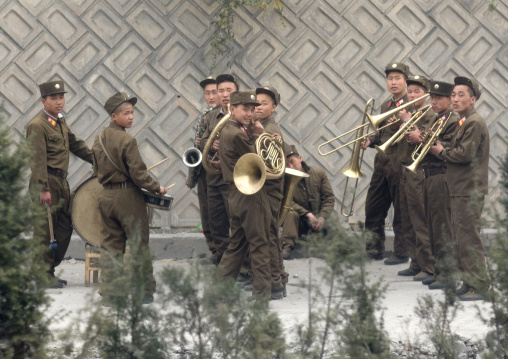 Military brass band on a highway playing for the North Korean workers, Pyongan Province, Pyongyang, North Korea