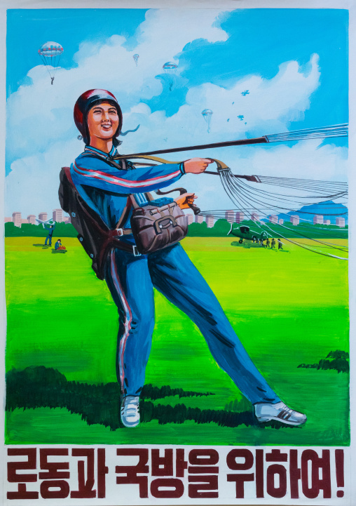 North Korean propaganda poster depicting a female paratrooper witht he slogan for work and national defense!, Pyongan Province, Pyongyang, North Korea