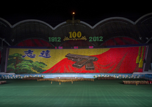 Kim il Sung pistol made by human pixels holding up colored boards during Arirang mass games in may day stadium, Pyongan Province, Pyongyang, North Korea