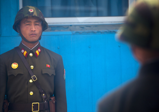 North Korean soldiers standing in front of the United Nations conference rooms on the demarcation line in the Demilitarized Zone, North Hwanghae Province, Panmunjom, North Korea