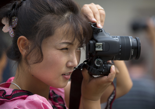 North Korean woman taking pictures, North Hwanghae Province, Kaesong, North Korea